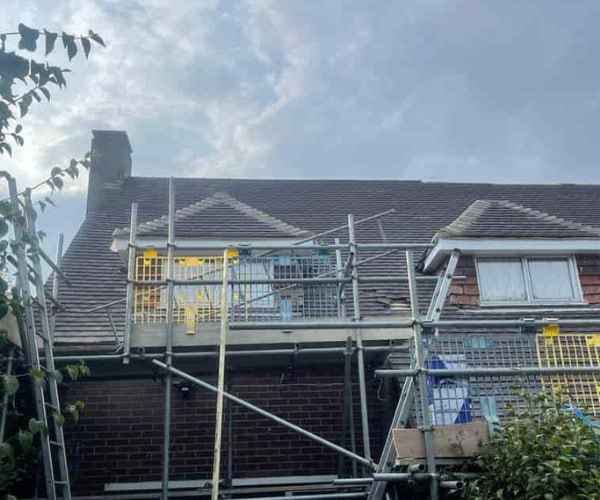 This is a photo of a roof with two dormers that is having some damaged tiles replaced. Works carried out by DHT Roofing Cudworth